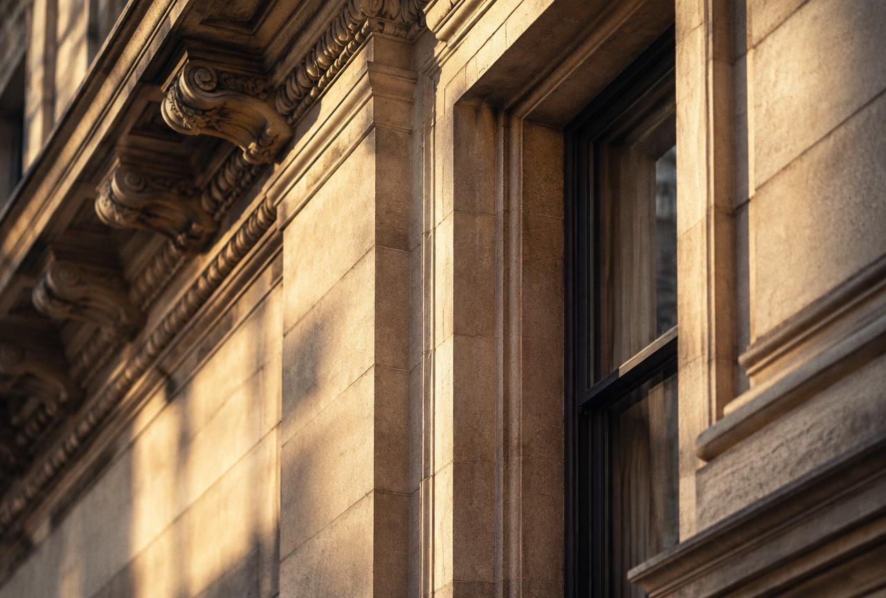 Carved limestone facade detail in warm afternoon light